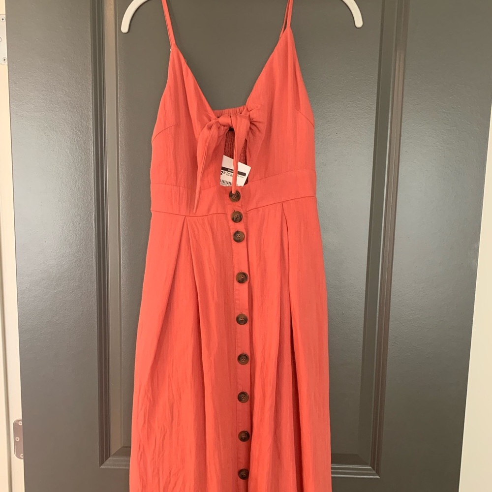 Kittenish peek-a-boo coral midi dress